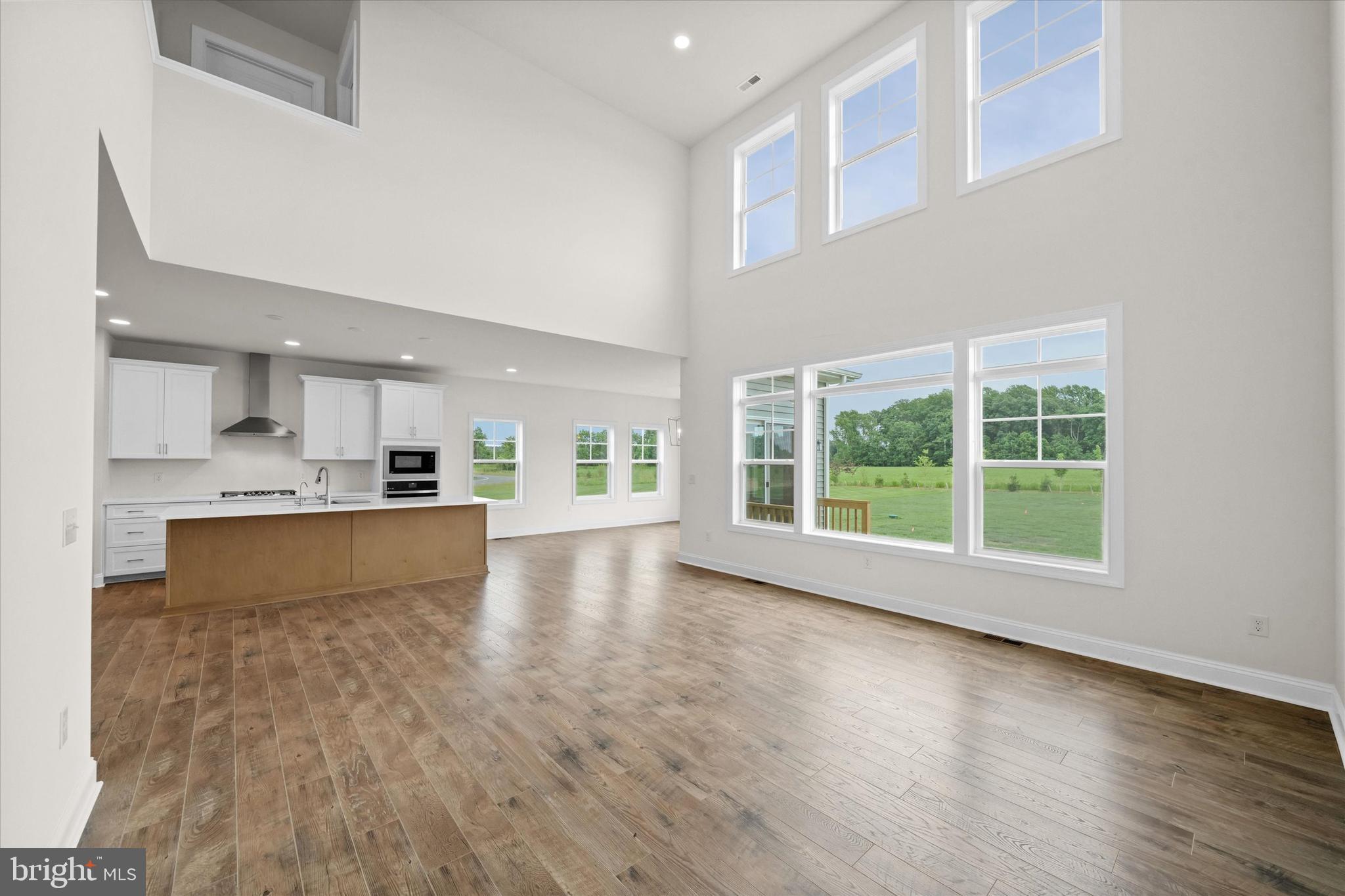 24025 Jerrico Road, Unit 38 Lincoln, DE 19960 - Photo 29 of 53 a large kitchen with stainless steel appliances granite countertop a large counter top and a wooden floors