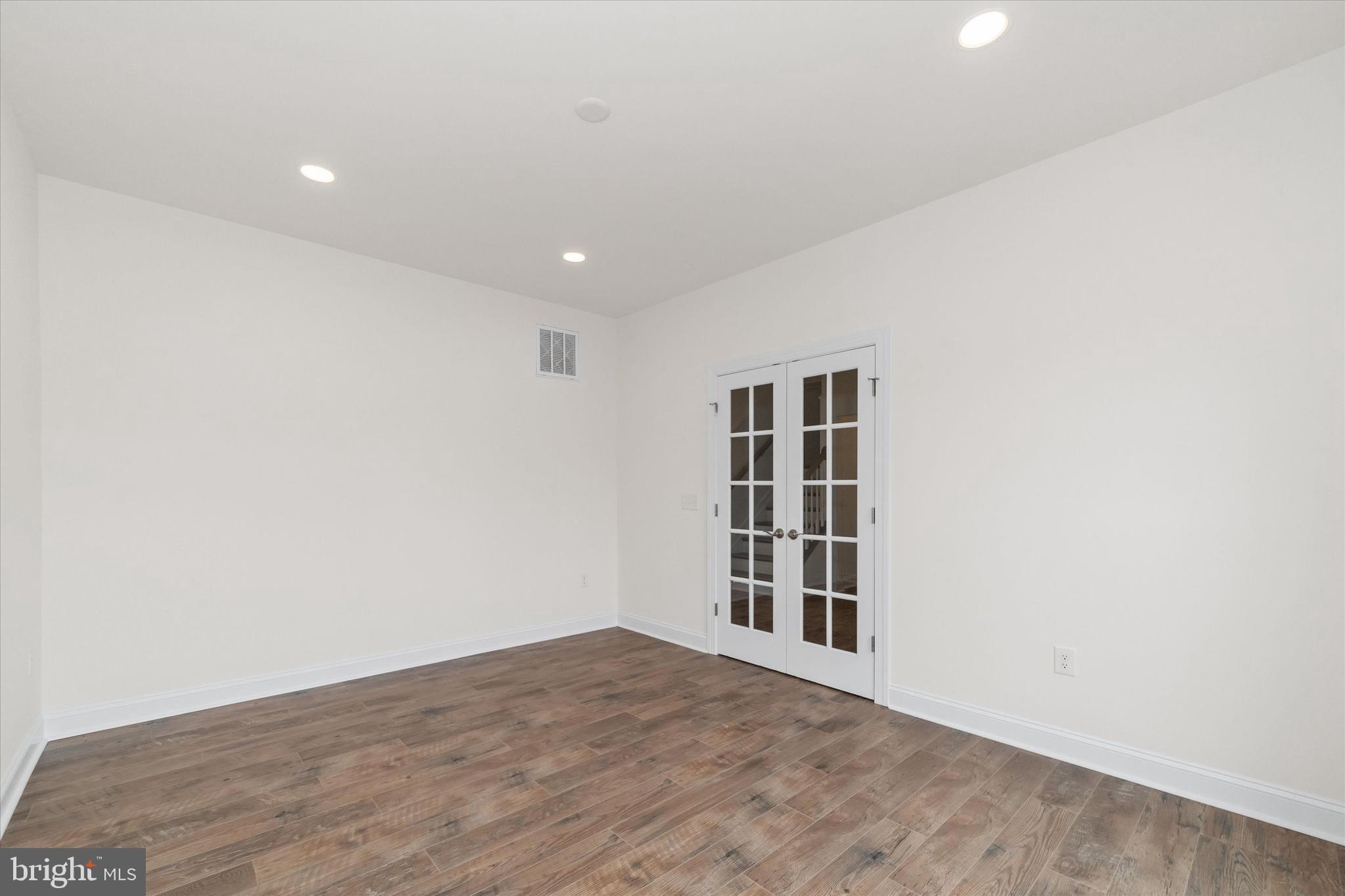 24025 Jerrico Road, Unit 38 Lincoln, DE 19960 - Photo 46 of 53 a view of empty room with wooden floor and windows