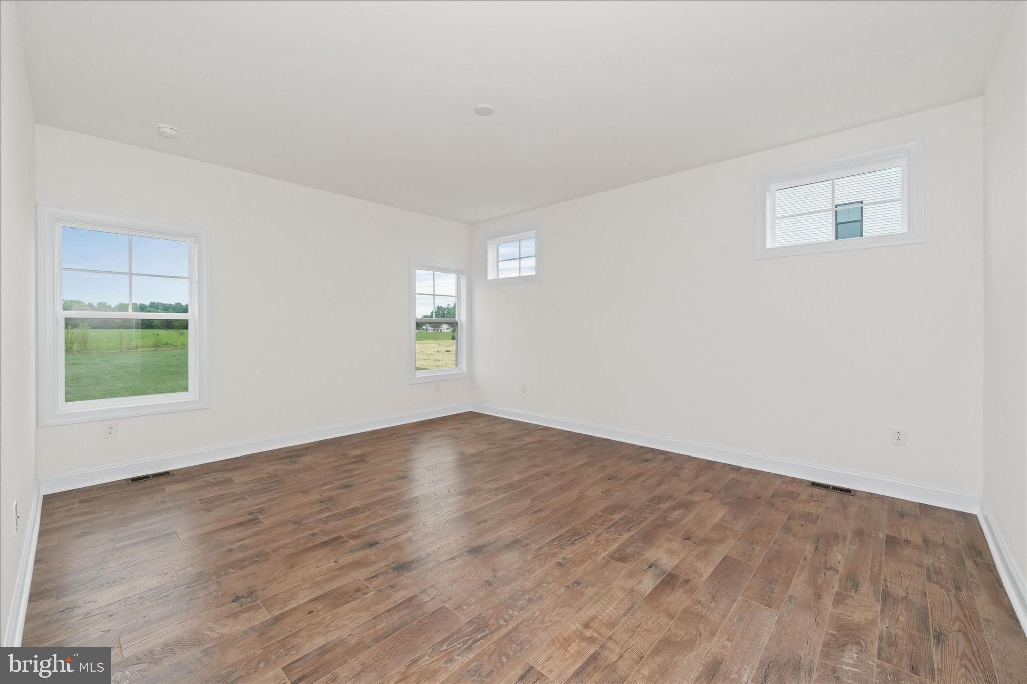 24025 Jerrico Road, Unit 38 Lincoln, DE 19960 - Photo 48 of 53 a view of an empty room with wooden floor and a window