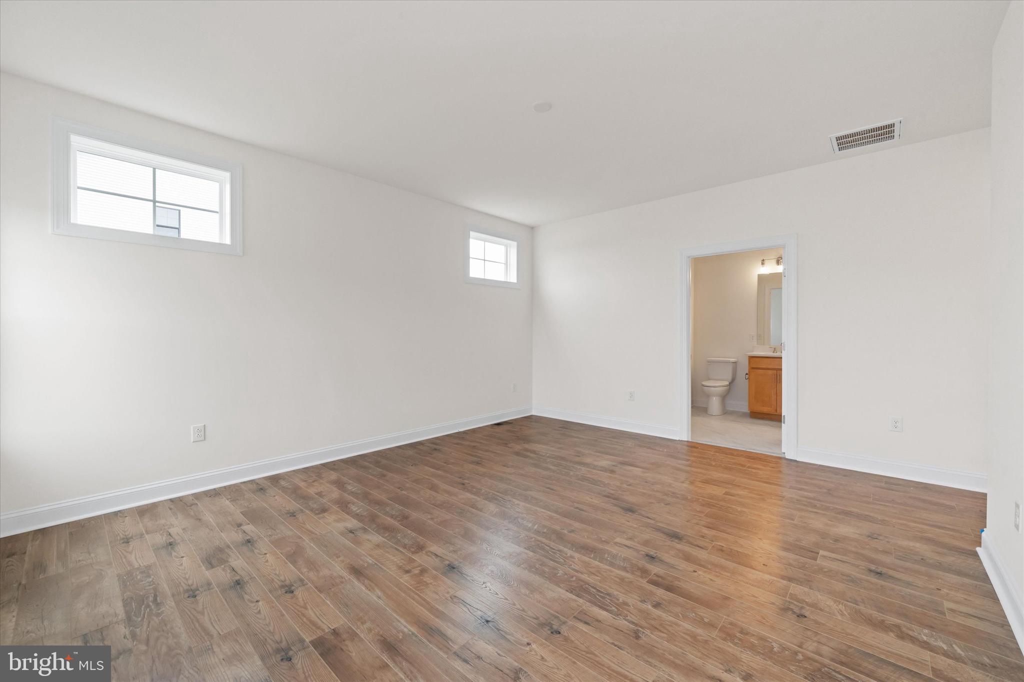 24025 Jerrico Road, Unit 38 Lincoln, DE 19960 - Photo 49 of 53 a view of an empty room with wooden floor and a window