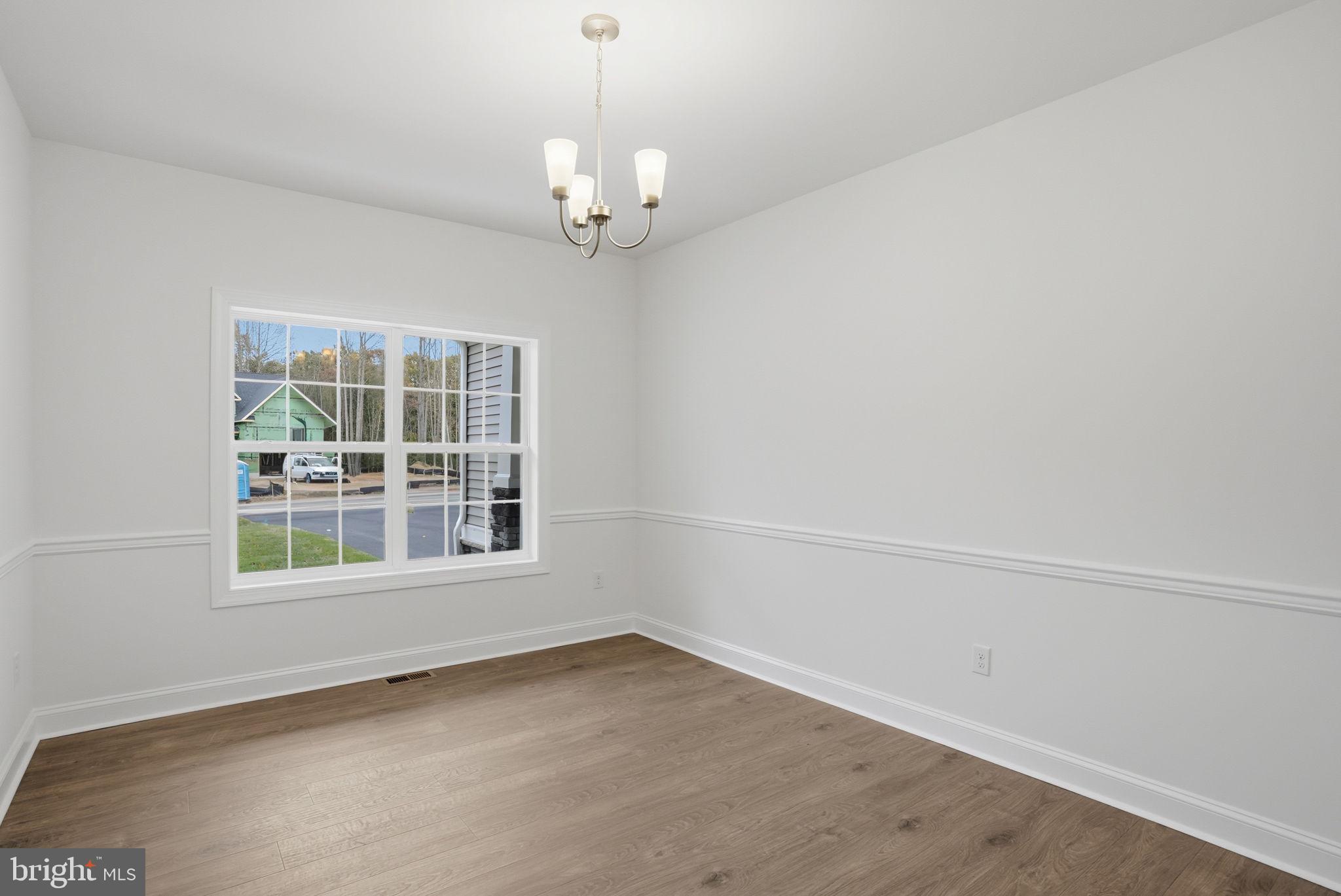 24025 Jerrico Road, Unit 38 Lincoln, DE 19960 - Photo 6 of 32 an empty room with a chandelier