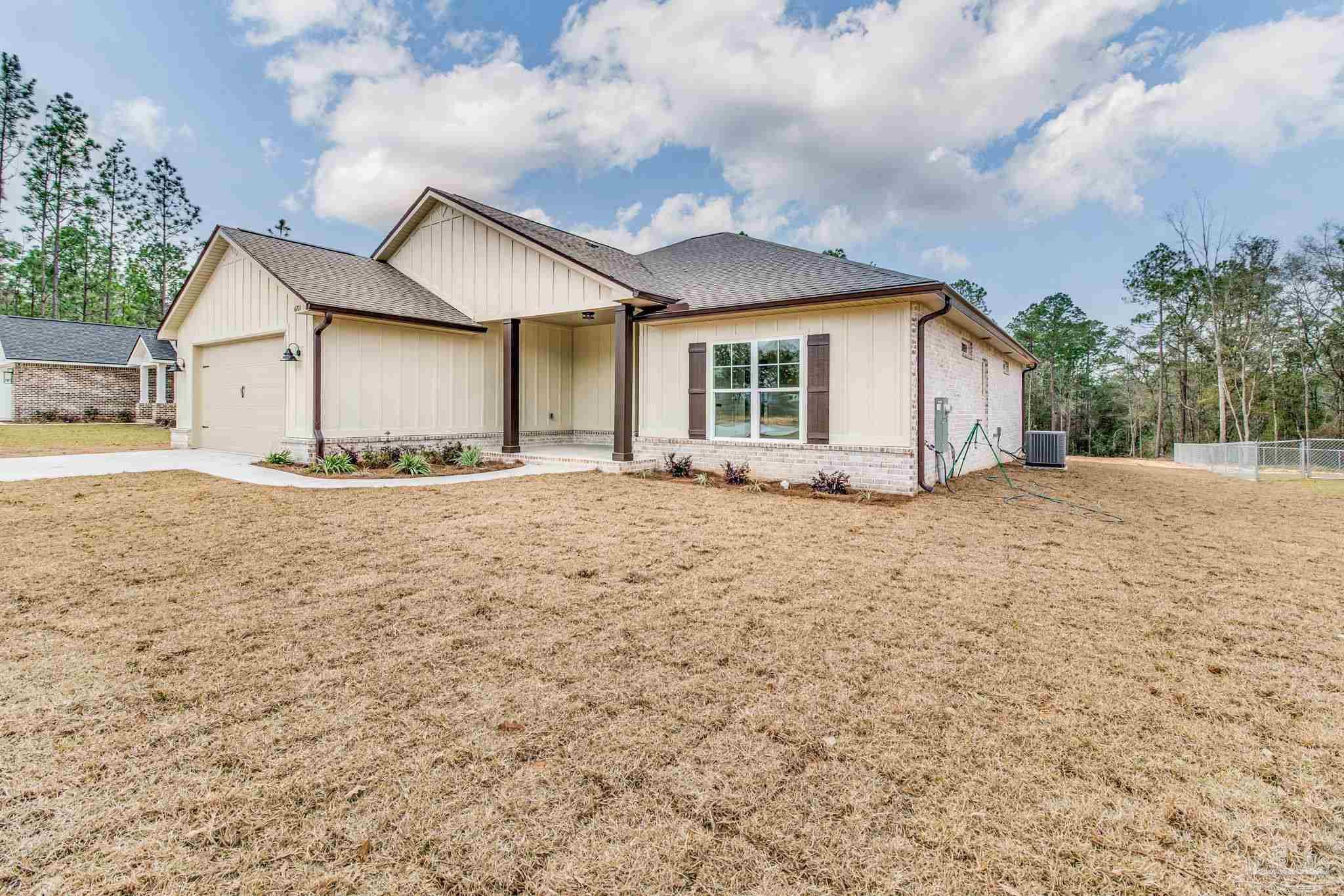 4310 Watkins Street Pace, FL 32571 - Photo 4 of 58 a front view of a house with a yard