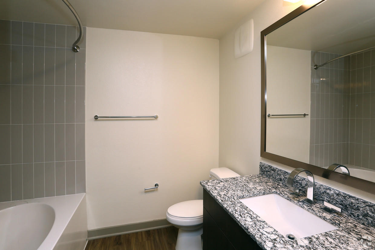 700 East Algonquin Road, Unit 2309 Schaumburg, IL 60173 - Photo 7 of 22 a bathroom with a granite countertop sink toilet and shower