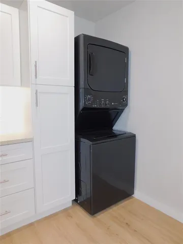a living room with a wooden floor and a wall painting