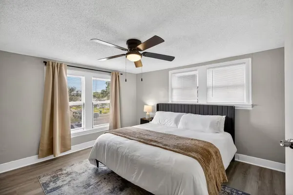 a kitchen with stainless steel appliances granite countertop a dining table chairs refrigerator and sink