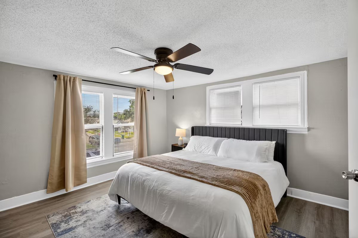 1401 Collier Street Houston, TX 77023 - Photo 11 of 18 a bedroom with a large bed and a large window