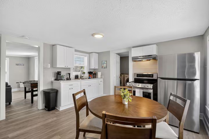 1401 Collier Street Houston, TX 77023 - Photo 12 of 18 a kitchen with stainless steel appliances granite countertop a dining table chairs refrigerator and sink