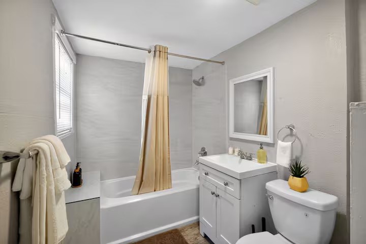 1401 Collier Street Houston, TX 77023 - Photo 14 of 18 a bathroom with a granite countertop sink toilet and shower