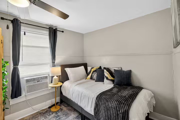 1401 Collier Street Houston, TX 77023 - Photo 15 of 18 a bedroom with a bed and a window