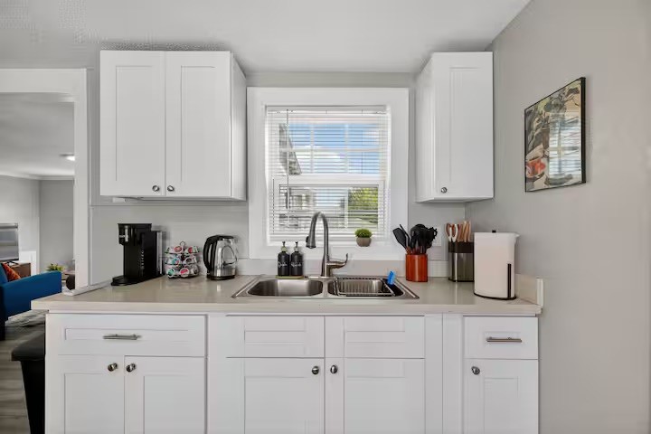 1401 Collier Street Houston, TX 77023 - Photo 10 of 18 a kitchen with white cabinets and window