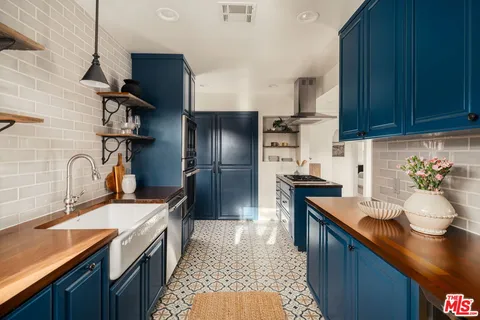 a kitchen with stainless steel appliances a sink stove and refrigerator