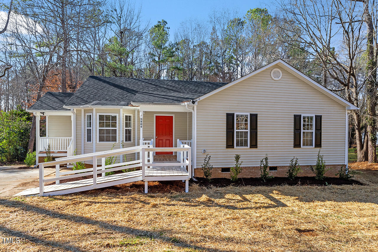 5404 Passenger Place Raleigh, NC 27603 - Photo 1 of 25 a backyard of a house with wooden fence and large trees
