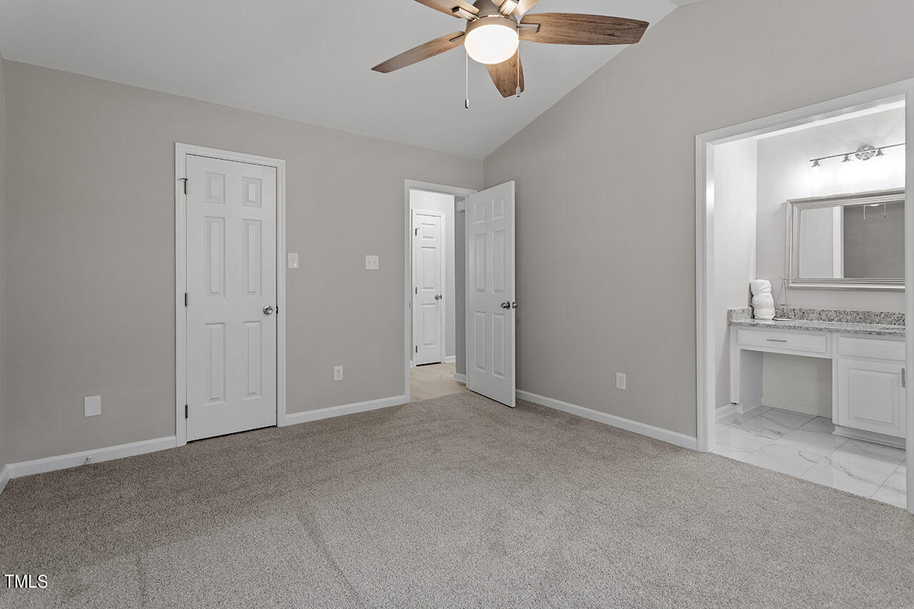 5404 Passenger Place Raleigh, NC 27603 - Photo 17 of 25 an empty room with a ceiling fan and a mirror