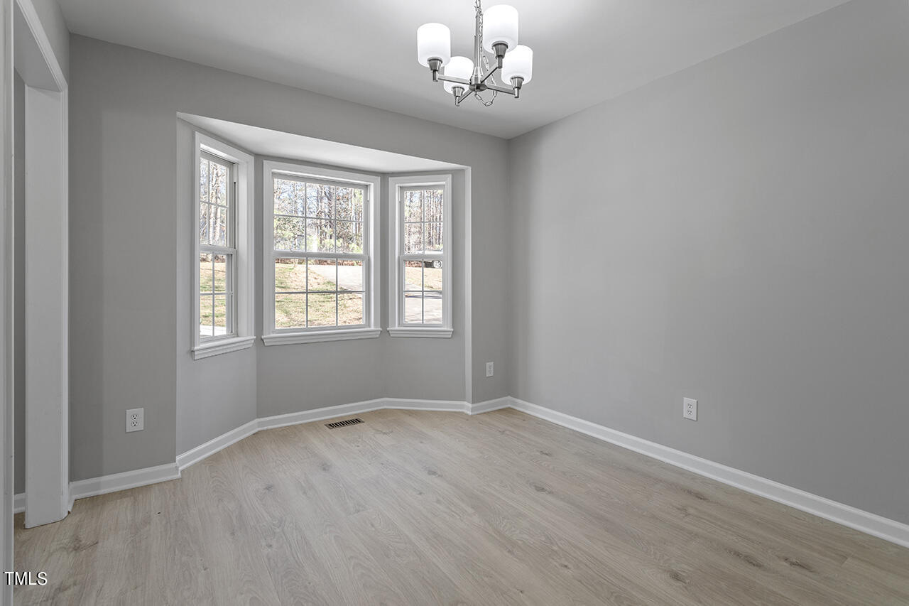 5404 Passenger Place Raleigh, NC 27603 - Photo 8 of 25 wooden floor in an empty room with a window