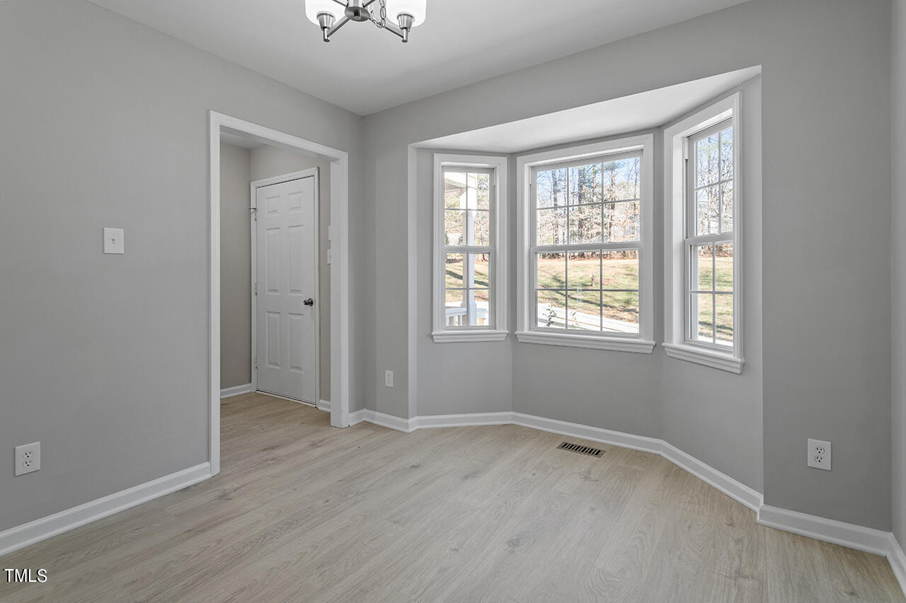 5404 Passenger Place Raleigh, NC 27603 - Photo 9 of 25 wooden floor in an empty room with a window