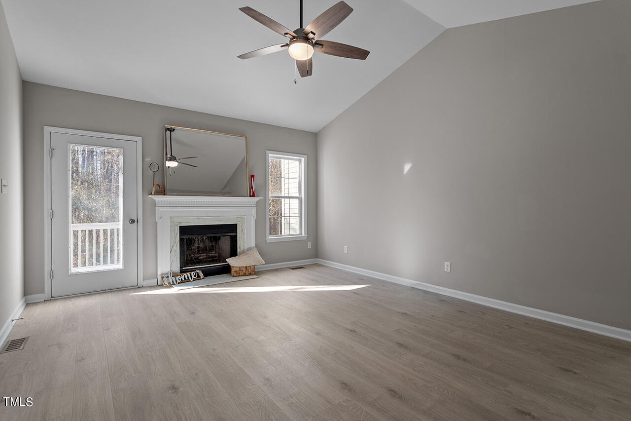 5404 Passenger Place Raleigh, NC 27603 - Photo 10 of 25 a view of an empty room with a fireplace and a window
