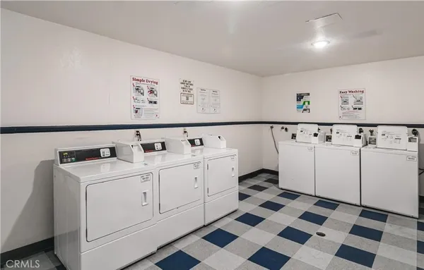 a utility room with cabinets washer and dryer