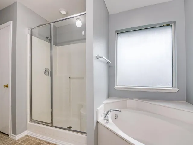 a bathroom with a bathtub and a shower