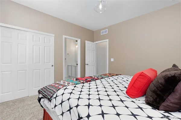 a bedroom with a bed and a lamp