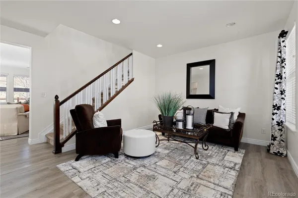 a living room with furniture and stairs