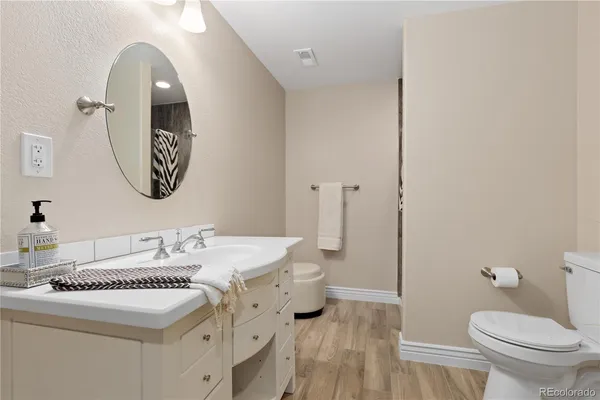 a bathroom with a toilet a sink and a mirror