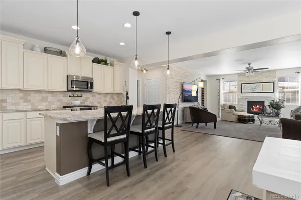 a large kitchen with a table and chairs