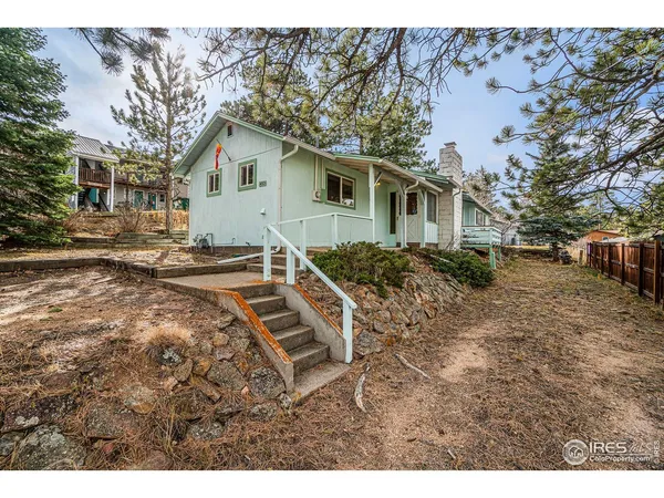a backyard of a house with barbeque oven table and chairs