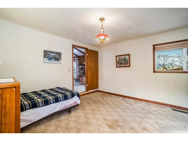 a spacious bedroom with a bed and a chandelier