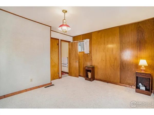 a view of empty room with wooden floor and windows