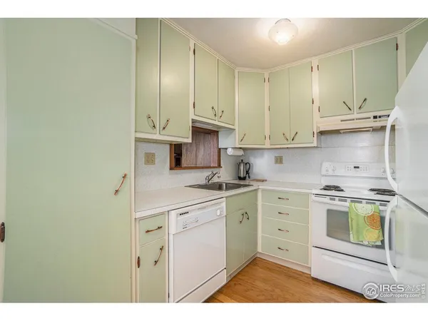 a kitchen with cabinets stainless steel appliances and a sink