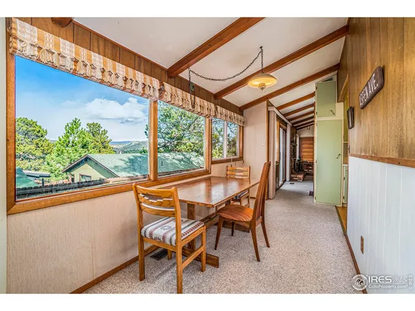 a dining room with furniture and a window