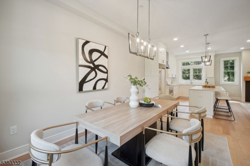 603 Springfield Avenue, Unit 102 Summit, NJ 07901 - Photo 1 of 5 a view of a dining room with furniture wooden floor and chandelier
