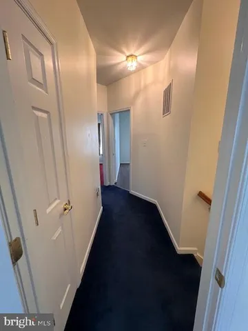 a view of a room with wooden floor a ceiling fan and a window