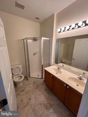a white toilet sitting next to a bath tub