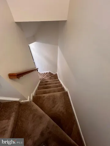 a view of livingroom with stairs and a window