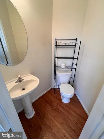 a view of walk in closet with wooden floor