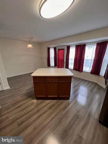 a view of an empty room and wooden floor