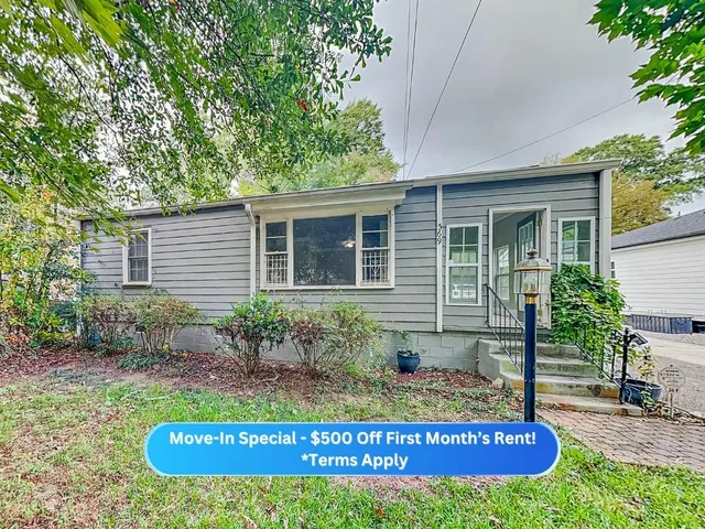 a view of a house with a yard and potted plants