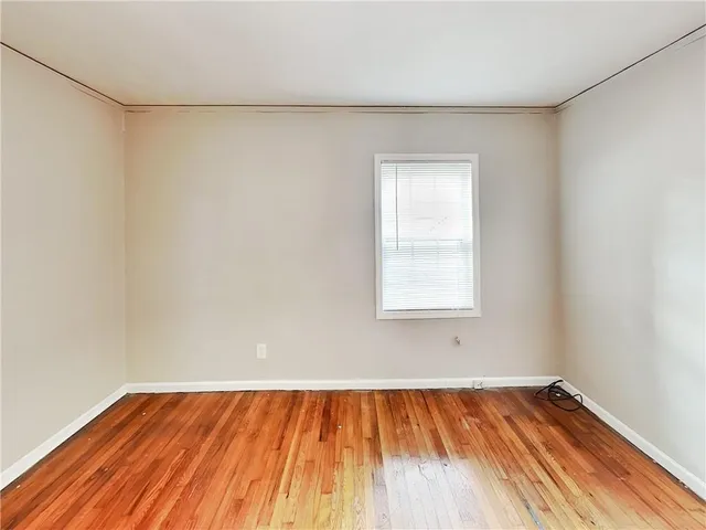 a view of a room with wooden floor and white walls