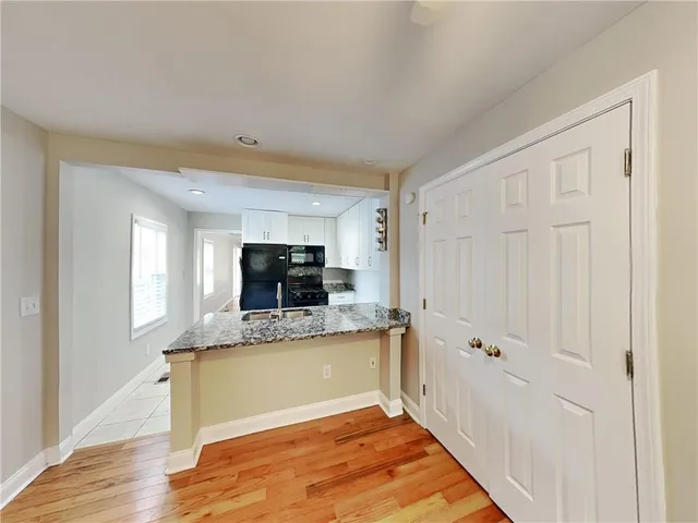 a view of a kitchen with a sink cabinet a fireplace and windows