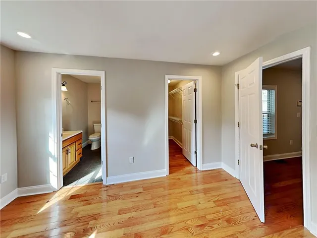 a view of an empty room and bathroom