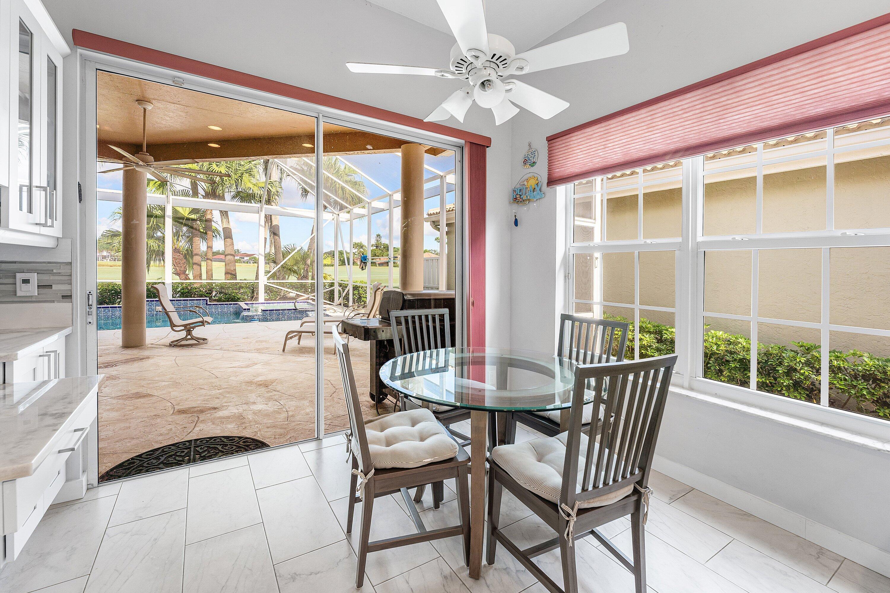 8217 Quail Meadow Way West Palm Beach, FL 33412 - Photo 15 of 38 a dining room with furniture a chandelier and wooden floor