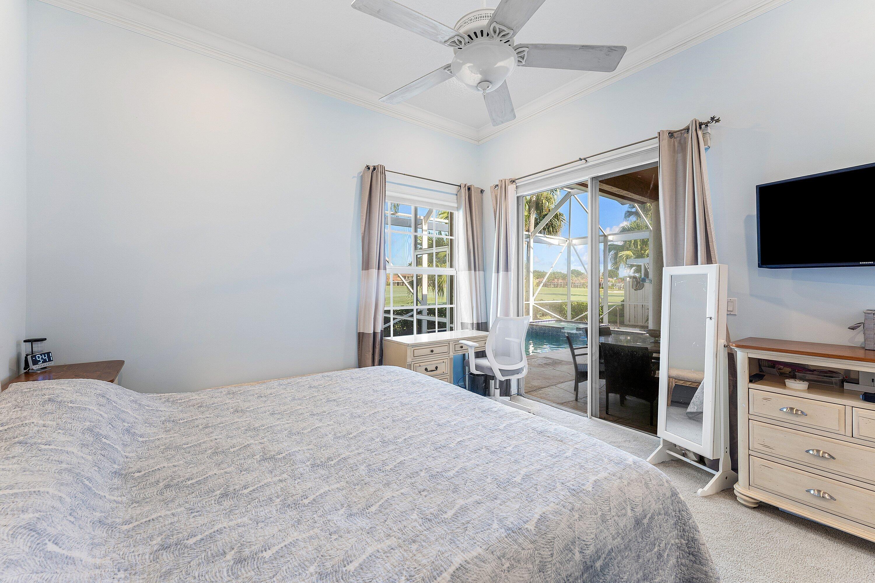 8217 Quail Meadow Way West Palm Beach, FL 33412 - Photo 17 of 38 a bedroom with a bed and a flat screen tv