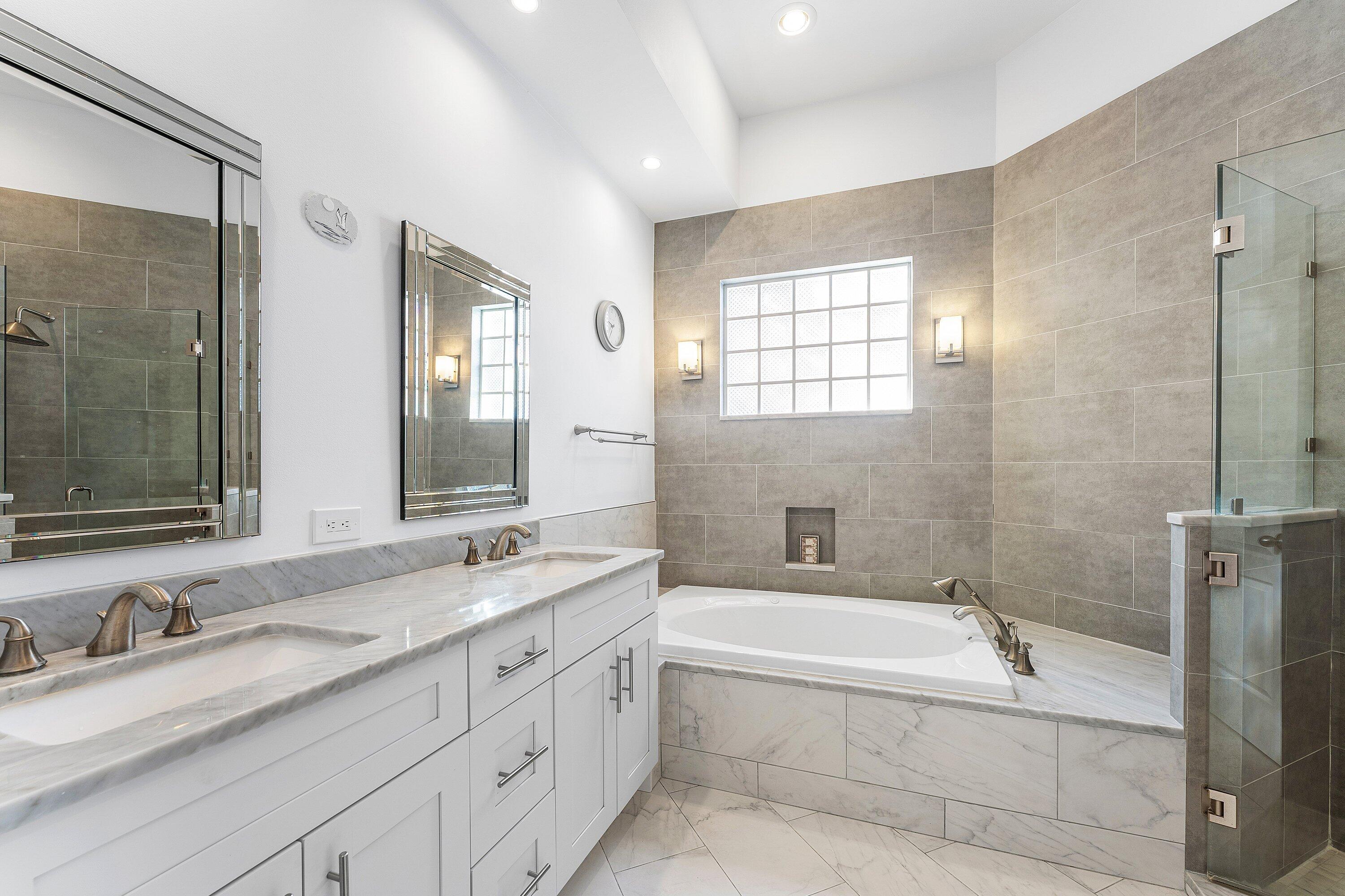 8217 Quail Meadow Way West Palm Beach, FL 33412 - Photo 19 of 38 a bathroom with a granite countertop bathtub shower sink double and mirror