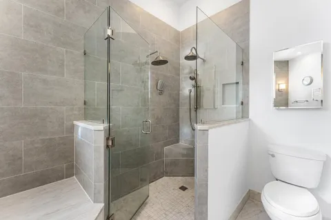 a bathroom with a shower and toilet