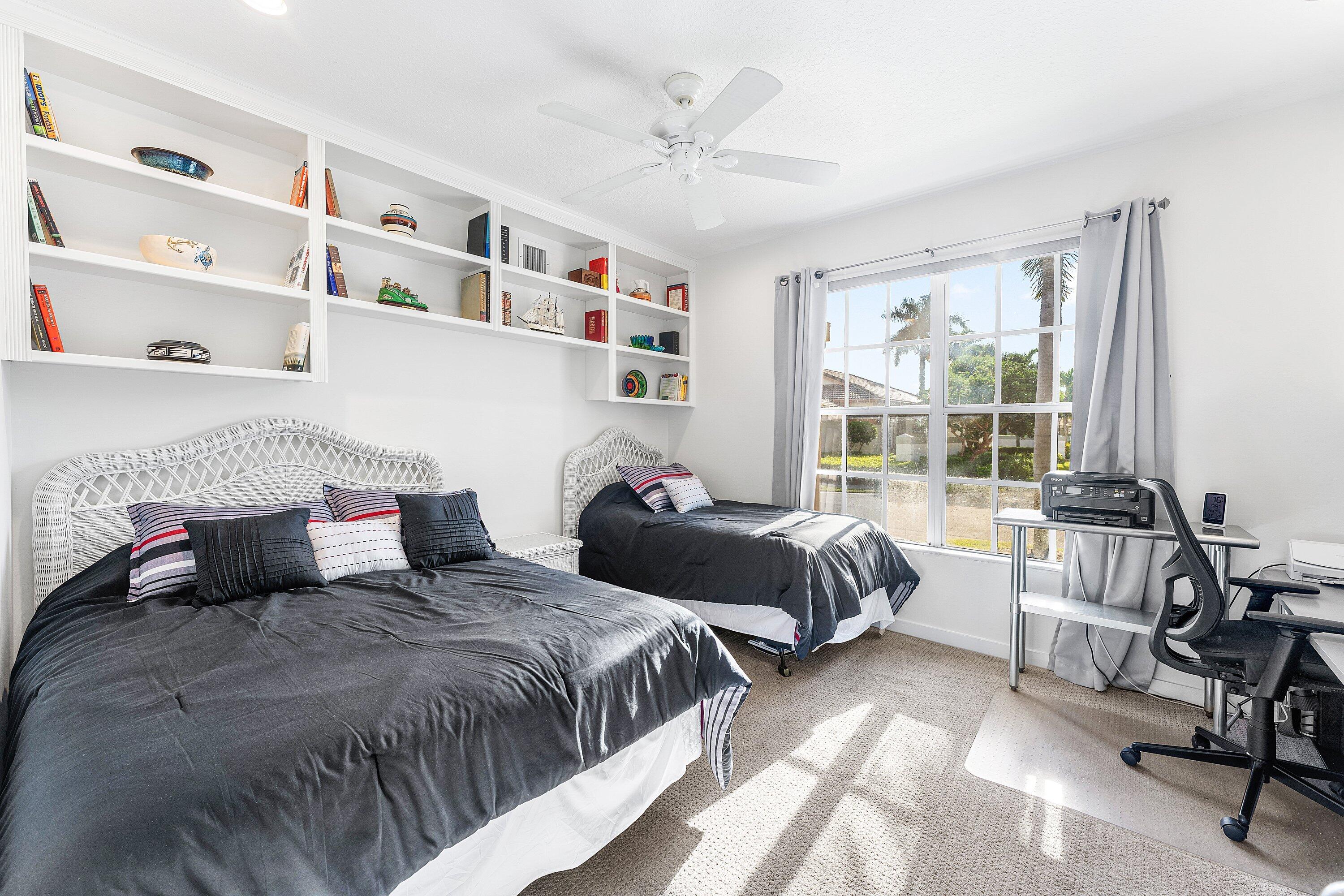 8217 Quail Meadow Way West Palm Beach, FL 33412 - Photo 21 of 38 a bedroom with two beds and a large window