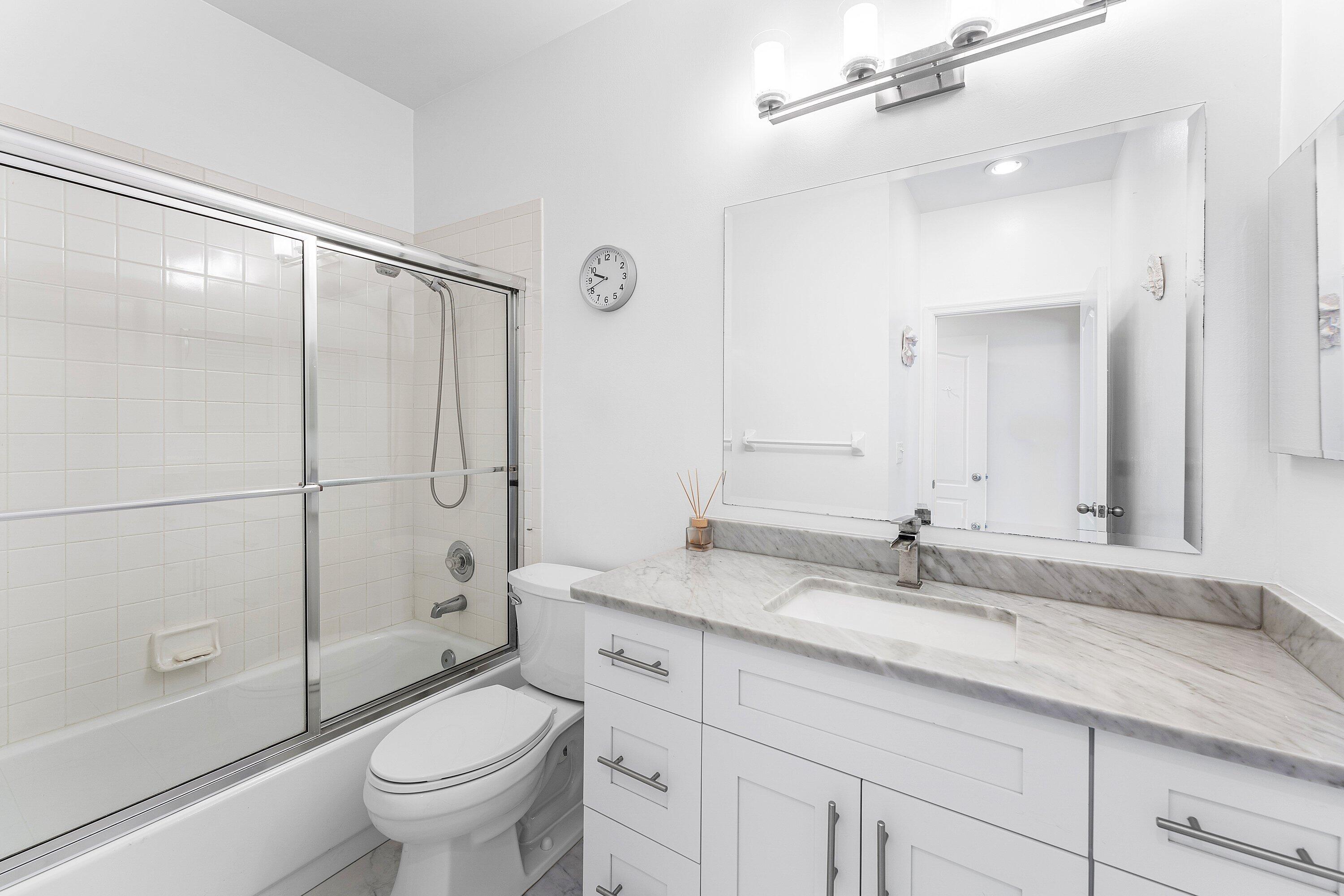 8217 Quail Meadow Way West Palm Beach, FL 33412 - Photo 22 of 38 a bathroom with a granite countertop sink a toilet and shower