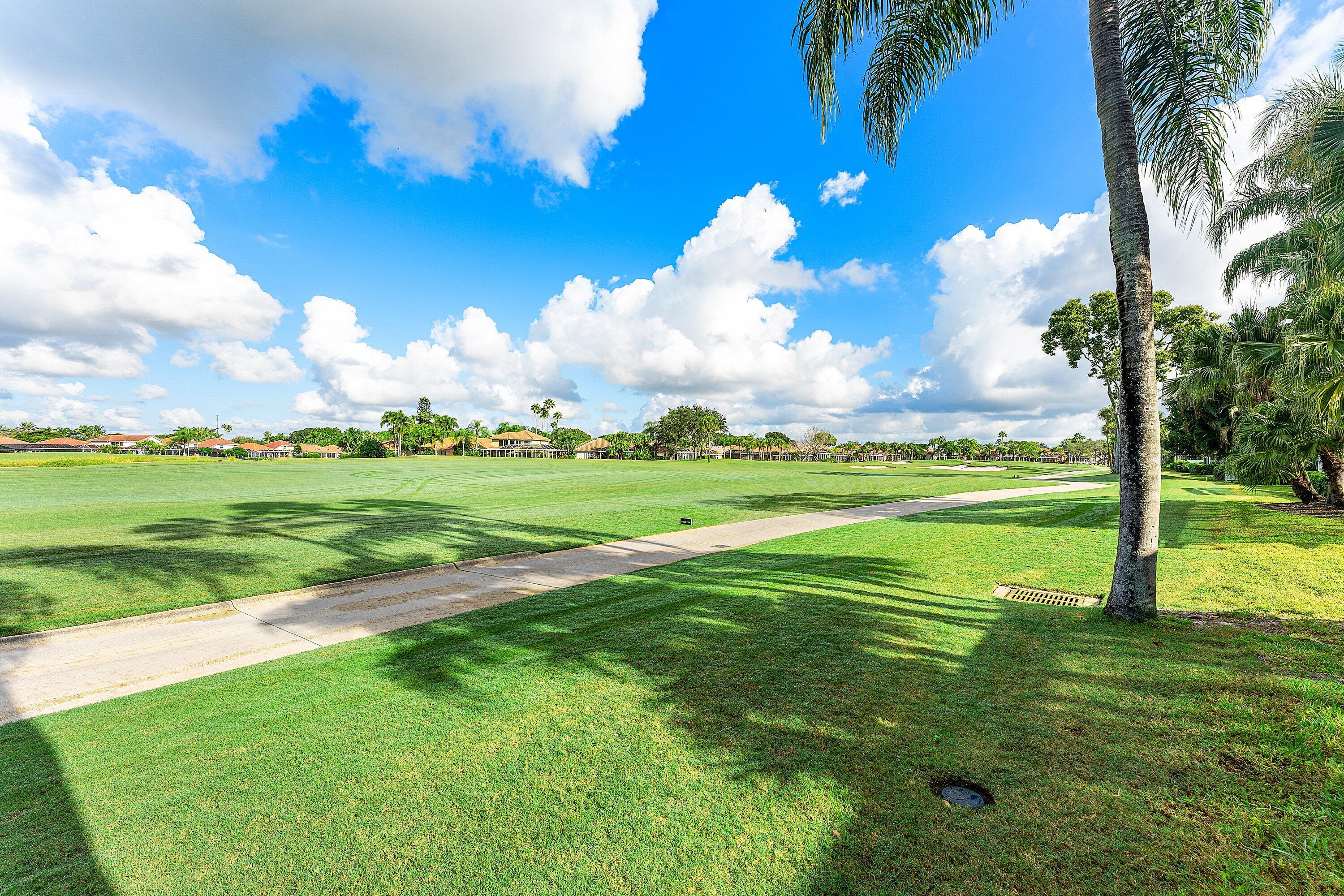8217 Quail Meadow Way West Palm Beach, FL 33412 - Photo 31 of 38 a view of a golf course with a lake