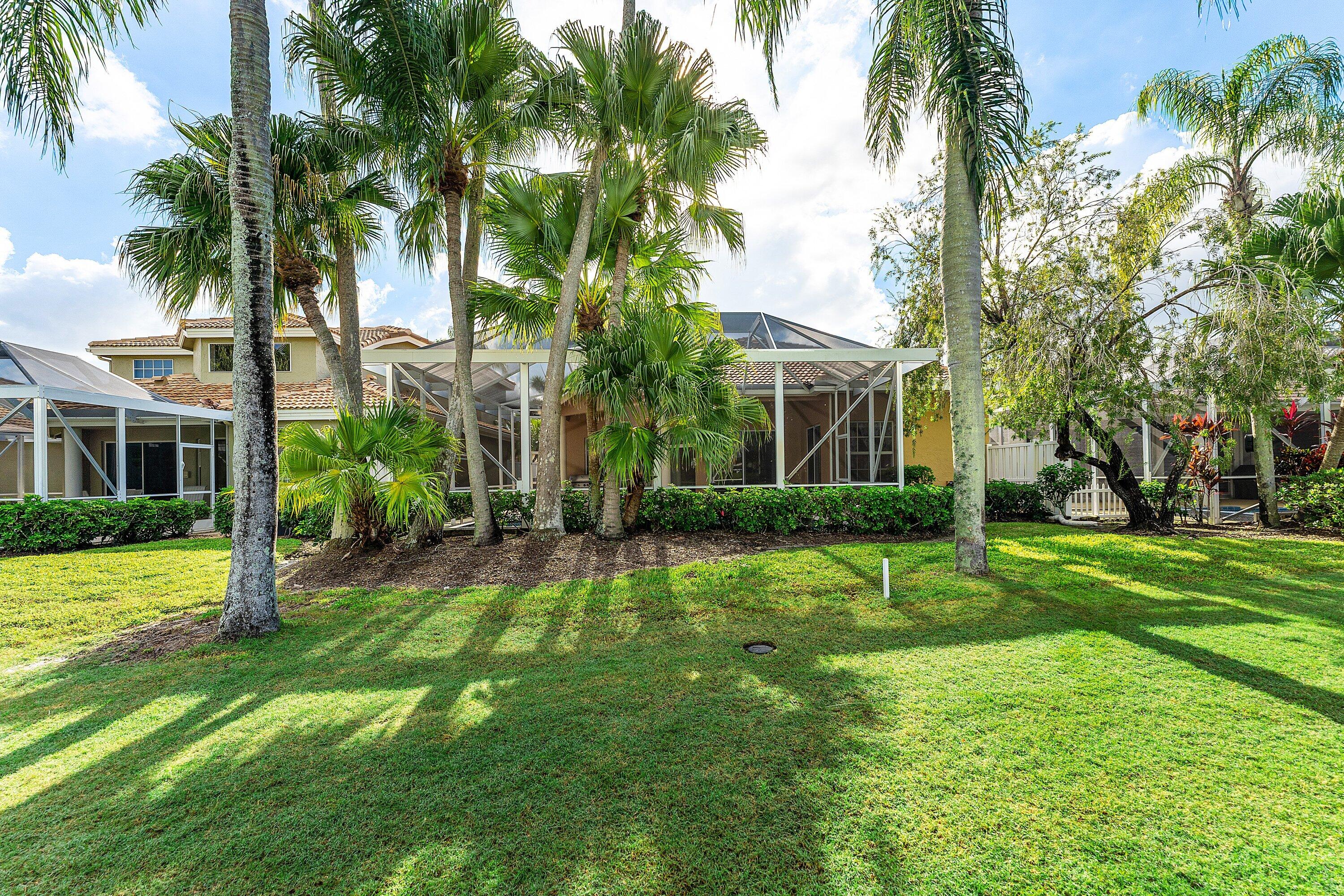 8217 Quail Meadow Way West Palm Beach, FL 33412 - Photo 32 of 38 a view of a house with a big yard and palm trees