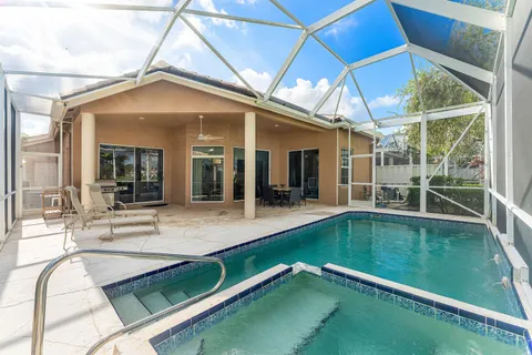 a view of a backyard with a swimming pool